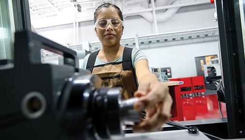 Female student working at a machine