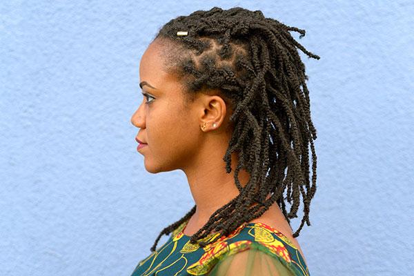 Side view portrait of a young African American woman with dreadlocks